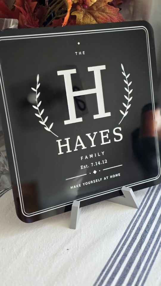 Black Hayes family sign with white H monogram, leafy branches, and a personalized established date