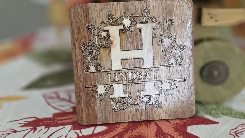 Floral H monogram and Lindsay name engraved into a small wood piece